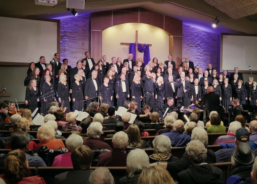 Mosaic performs at a church with a cross in the back of the stage